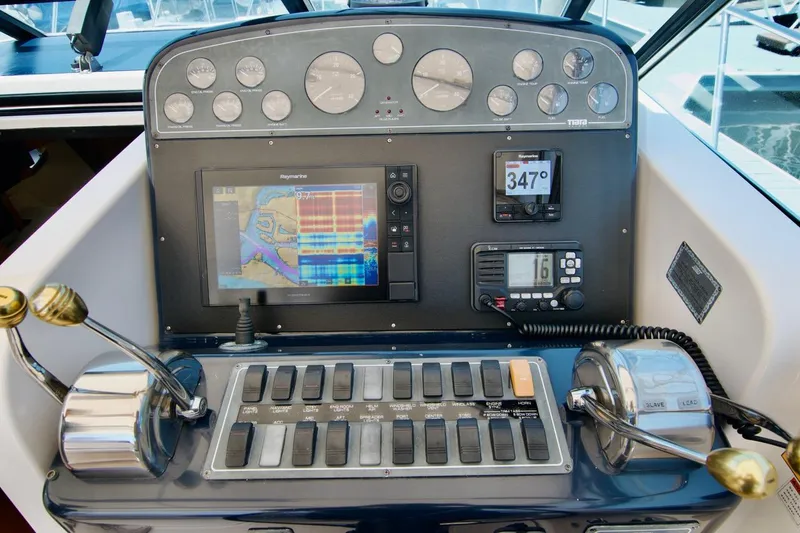 Revelry Yacht Photos Pics Tiara Yachts 3500 Open 2002 helm with navigation instruments and controls.