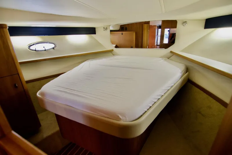 Revelry Yacht Photos Pics 2002 Tiara Yachts 3500 Open cabin interior with bed and porthole window.