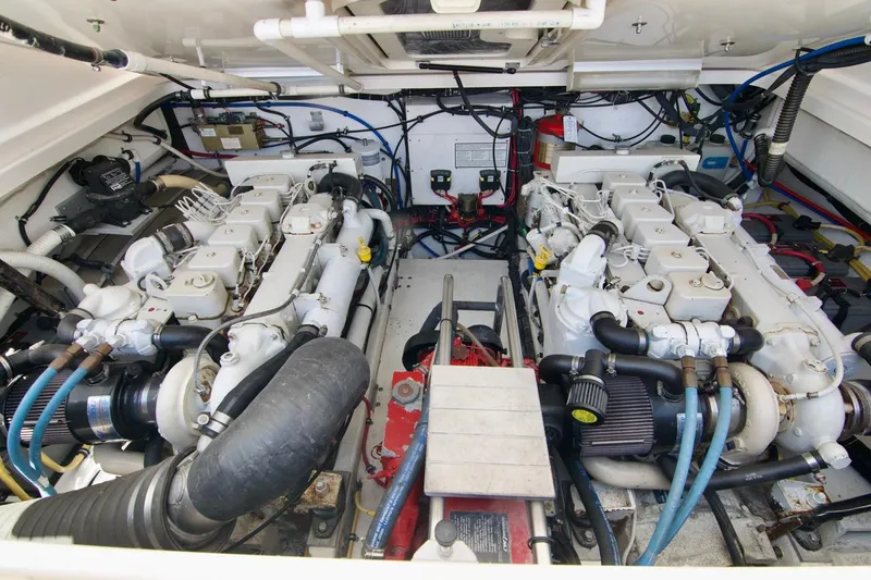 Revelry Yacht Photos Pics Engine room of a 2002 Tiara Yachts 3500 Open, showcasing dual engines and mechanical components.