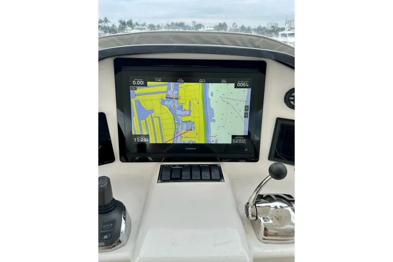 My Reality Yacht Photos Pics Navigation system on 2012 Neptunus 62 Flybridge yacht's helm displaying a digital map.