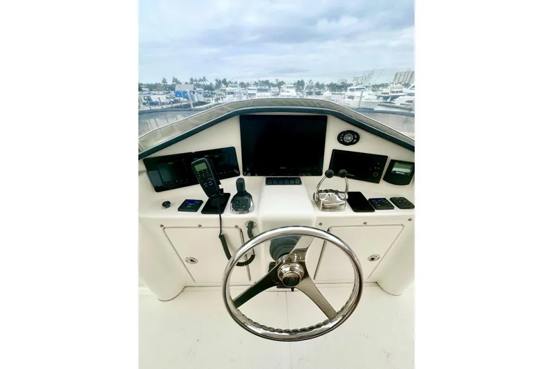 My Reality Yacht Photos Pics Helm of 2012 Neptunus 62 Flybridge yacht with steering wheel and navigation equipment.