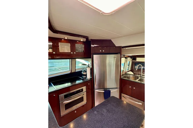 My Reality Yacht Photos Pics Luxurious kitchen interior of 2012 Neptunus 62 Flybridge yacht with modern appliances.