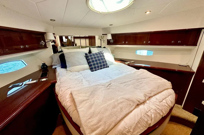 My Reality Yacht Photos Pics Luxurious 2012 Neptunus 62 Flybridge yacht bedroom with elegant wood finishes.