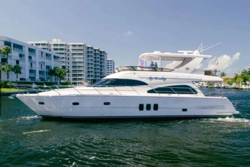 My Reality Yacht Photos Pics 2012 Neptunus 62 Flybridge yacht cruising near waterfront buildings.