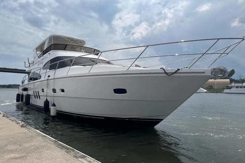 My Reality Yacht Photos Pics Luxury 2012 Neptunus 62 Flybridge yacht docked on a sunny day.