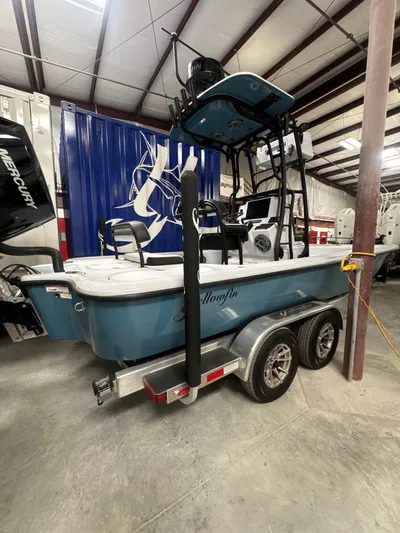  Yacht Photos Pics 2025 Yellowfin 24 CE boat on trailer in indoor storage facility.