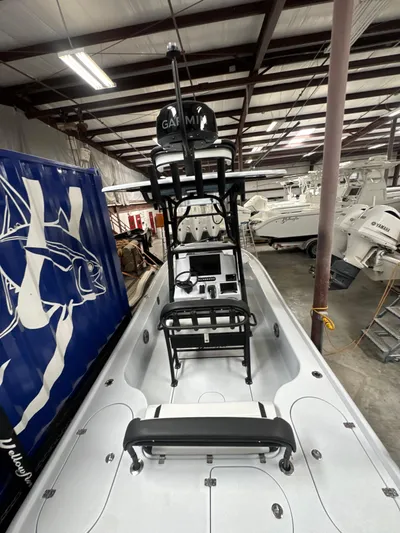  Yacht Photos Pics 2025 Yellowfin 24 CE boat in a warehouse, featuring advanced navigation equipment.