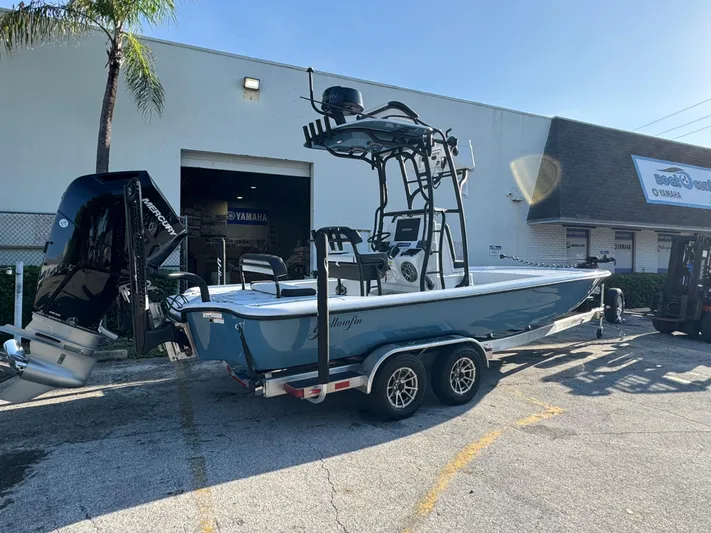  Yacht Photos Pics 2025 Yellowfin 24 CE boat on trailer outside Yamaha dealership.