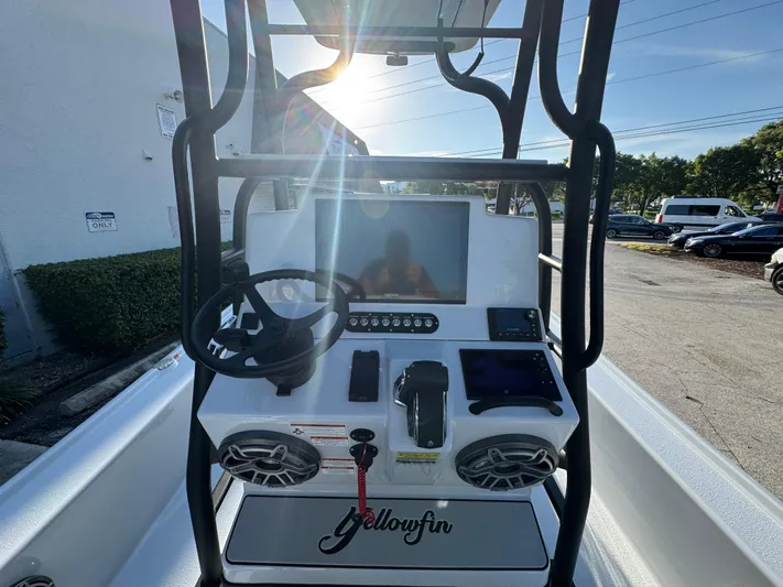  Yacht Photos Pics 2025 Yellowfin 24 CE boat console with steering wheel and electronic controls.