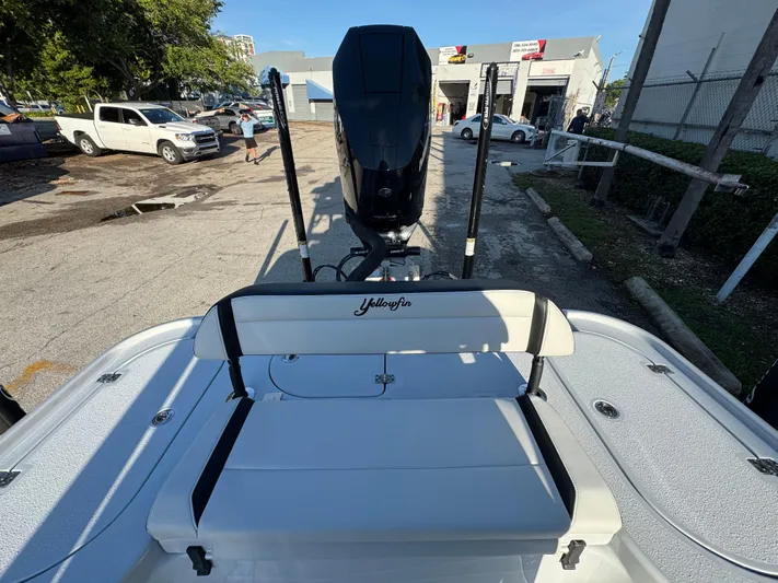  Yacht Photos Pics 2025 Yellowfin 24 CE boat with seating and motor, parked outdoors.