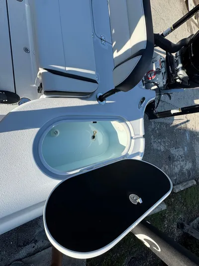  Yacht Photos Pics 2025 Yellowfin 24 CE boat interior with seating and storage compartment.