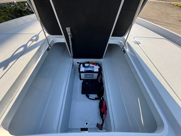  Yacht Photos Pics Open storage compartment of 2025 Yellowfin 24 CE boat with marine battery.