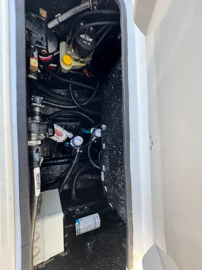  Yacht Photos Pics 2025 Yellowfin 24 CE boat compartment with mechanical components and wiring.