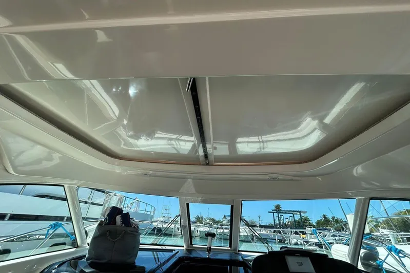  Yacht Photos Pics Interior view of 2012 Tiara Yachts 3100 Coronet with sunroof and marina background.