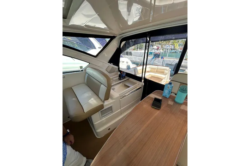  Yacht Photos Pics Interior of 2012 Tiara Yachts 3100 Coronet, featuring seating and table setup.