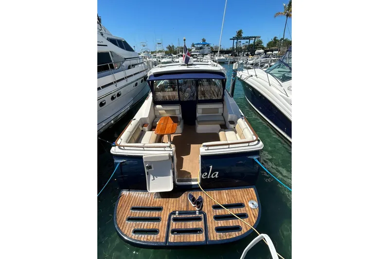  Yacht Photos Pics 2012 Tiara Yachts 3100 Coronet docked, featuring spacious seating and wooden deck.