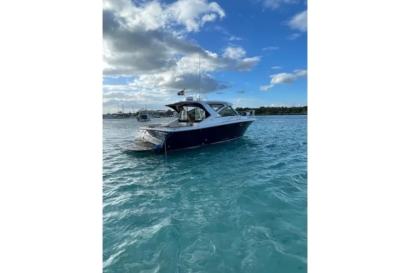  Yacht Photos Pics 2012 Tiara Yachts 3100 Coronet on clear blue water under a partly cloudy sky.