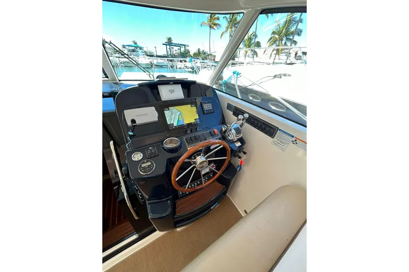  Yacht Photos Pics 2012 Tiara Yachts 3100 Coronet helm with navigation equipment and wooden steering wheel.