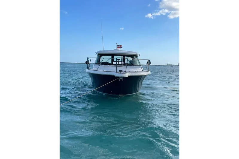  Yacht Photos Pics 2012 Tiara Yachts 3100 Coronet anchored on clear blue water.