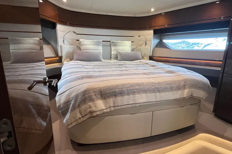  Yacht Photos Pics Luxurious bedroom in 2016 Princess 68 Flybridge Motor Yacht with elegant bedding and scenic window view.