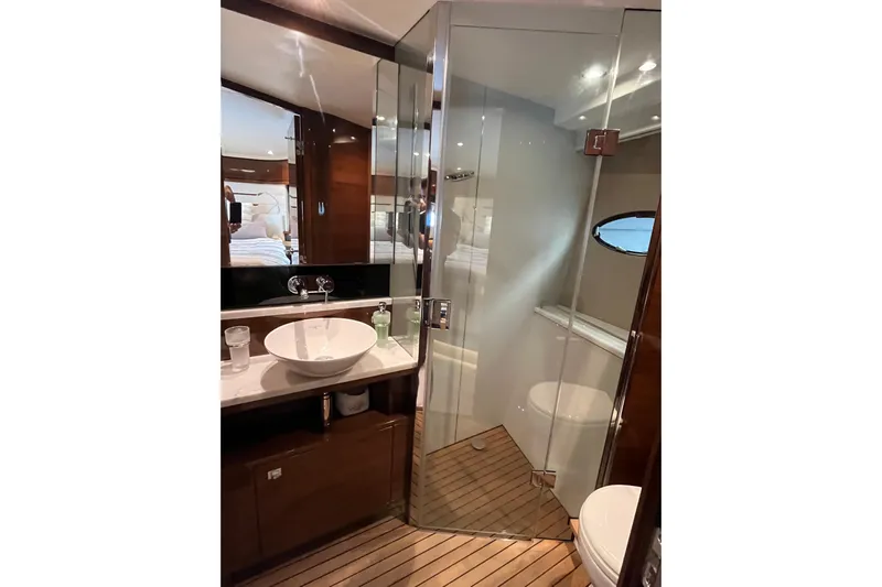  Yacht Photos Pics Luxurious bathroom in 2016 Princess 68 Flybridge Motor Yacht with glass shower and modern fixtures.