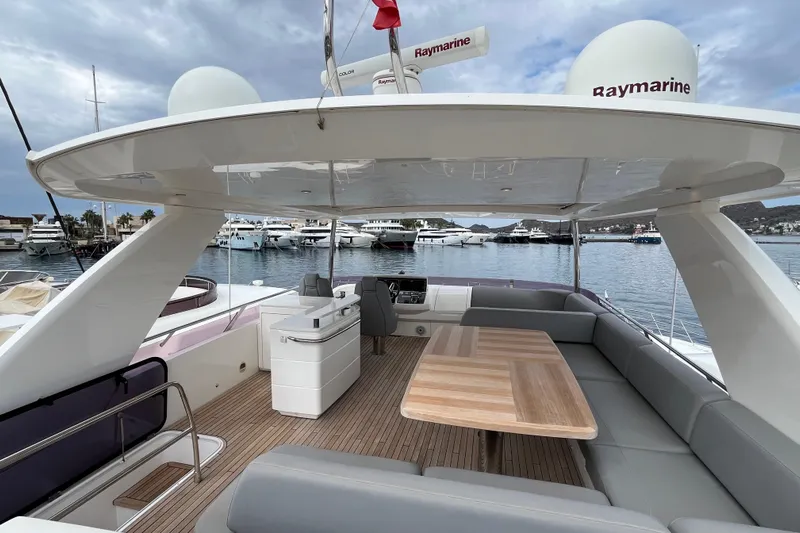  Yacht Photos Pics Flybridge of 2016 Princess 68 Yacht with seating, table, and marina view.