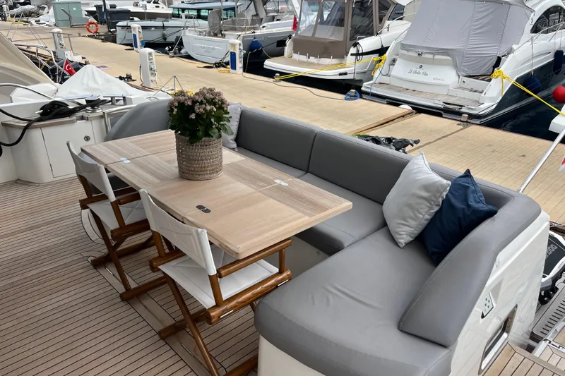  Yacht Photos Pics Luxurious seating area on 2016 Princess 68 Flybridge Motor Yacht, docked at marina.