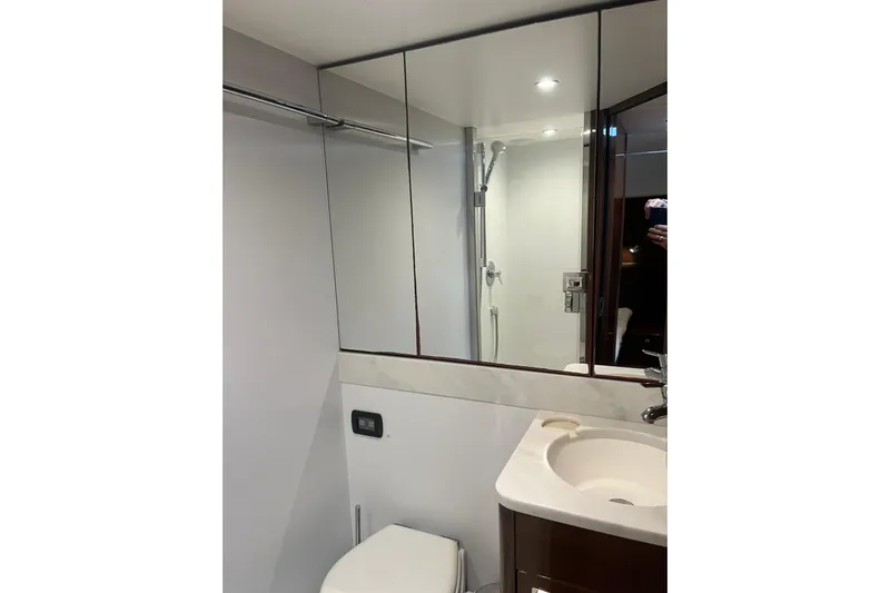  Yacht Photos Pics Bathroom interior of 2016 Princess 68 Flybridge Motor Yacht, featuring modern fixtures and mirrored cabinets.