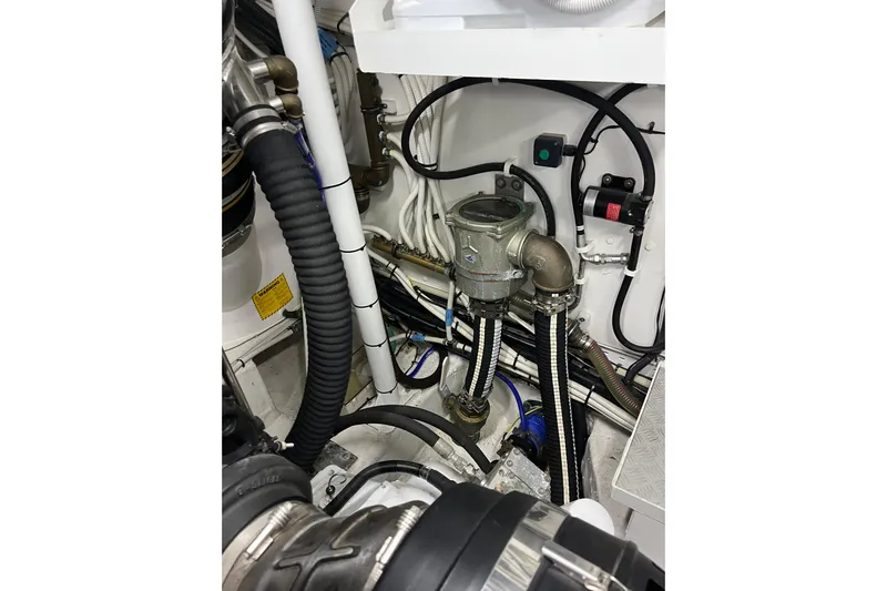  Yacht Photos Pics Engine room of 2016 Princess 68 Flybridge Motor Yacht, showcasing complex piping and wiring.