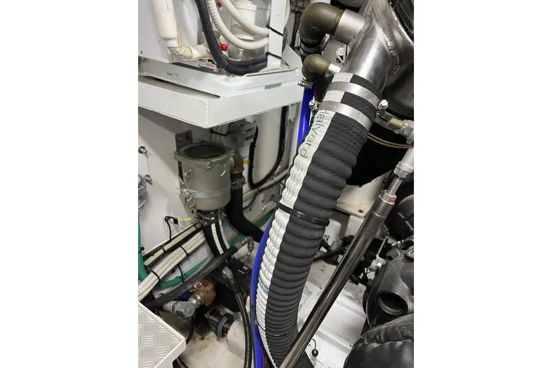  Yacht Photos Pics Engine room of 2016 Princess 68 Flybridge Motor Yacht, showcasing hoses and mechanical components.