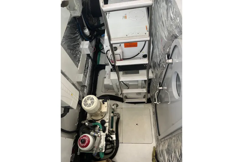  Yacht Photos Pics Engine room of 2016 Princess 68 Flybridge Motor Yacht, featuring mechanical equipment and ladder.