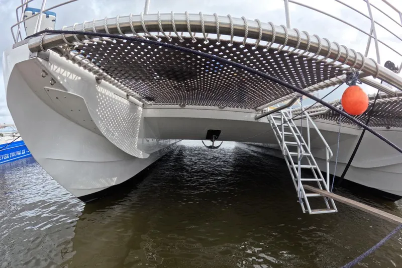  Yacht Photos Pics Custom PaxCat 80 catamaran, 2024 model, docked with visible netting and ladder.