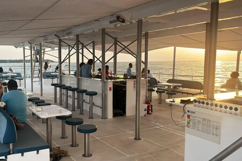  Yacht Photos Pics Modern PaxCat 80 boat interior with bar and seating, sunset view over the ocean, 2024 model.