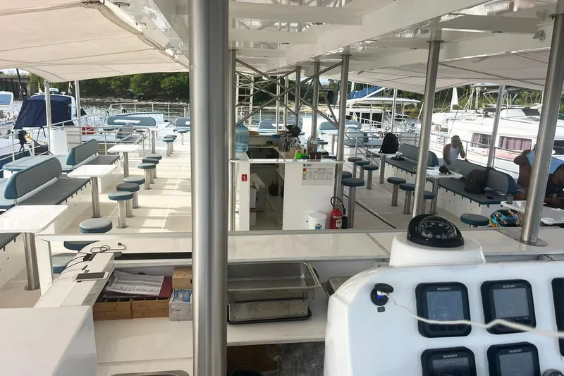  Yacht Photos Pics Spacious deck of 2024 Custom PaxCat 80 catamaran with seating and navigation equipment.