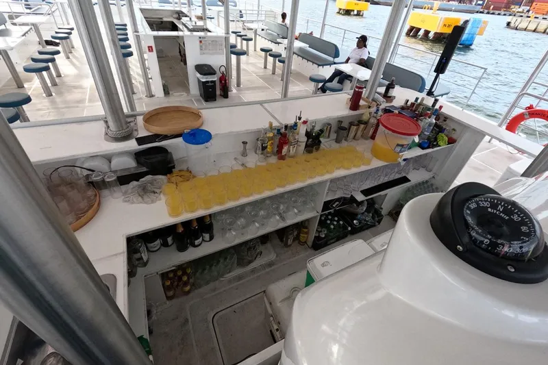  Yacht Photos Pics Boat bar setup on Custom PaxCat 80, 2024, with drinks and seating by the water.