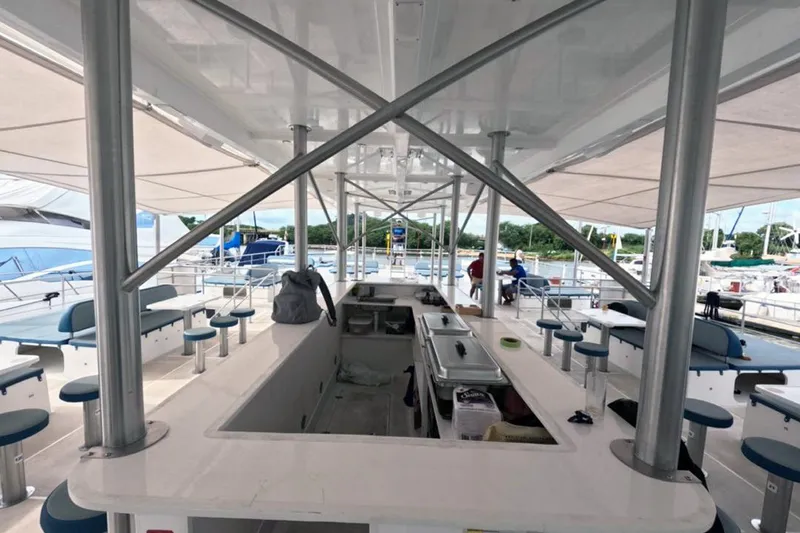  Yacht Photos Pics Spacious deck of 2024 Custom PaxCat 80 with seating and bar area.