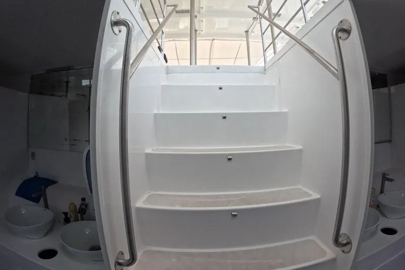  Yacht Photos Pics White staircase with metal railings inside a 2024 Custom PaxCat 80 yacht.