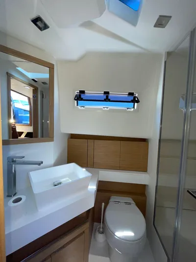  Yacht Photos Pics Modern bathroom in 2024 Pardo Yachts 43, featuring sleek sink, toilet, and window.