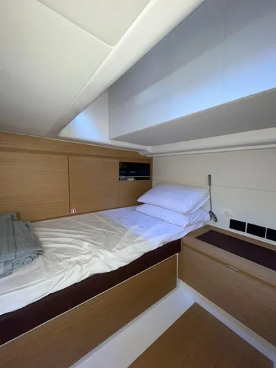  Yacht Photos Pics 2024 Pardo Yachts 43 cabin interior with modern wood finish and cozy bedding.