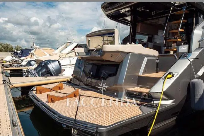  Yacht Photos Pics Luxury Cranchi E52S yacht, 2021 model, docked at marina with wooden deck.