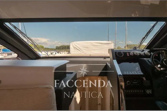  Yacht Photos Pics Interior view of 2021 Cranchi E52S yacht cockpit with modern controls and panoramic windows.