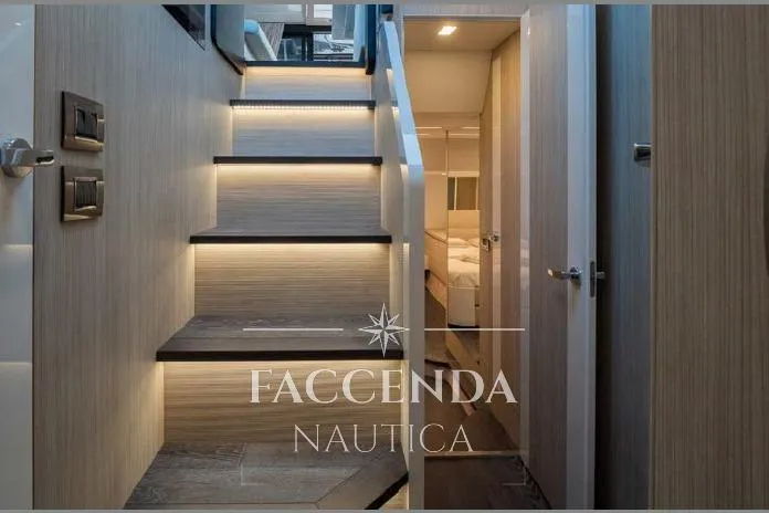  Yacht Photos Pics Modern interior of 2021 Cranchi E52S yacht with illuminated stairs and cabin view.