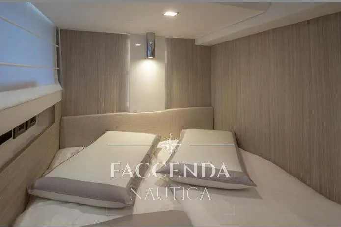  Yacht Photos Pics Luxurious interior cabin of 2021 Cranchi E52S yacht with modern design and cozy bedding.