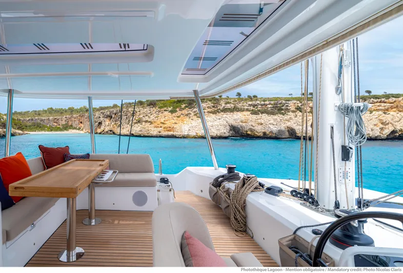  Yacht Photos Pics Luxurious 2024 Lagoon 55 yacht interior with ocean view and elegant seating area.
