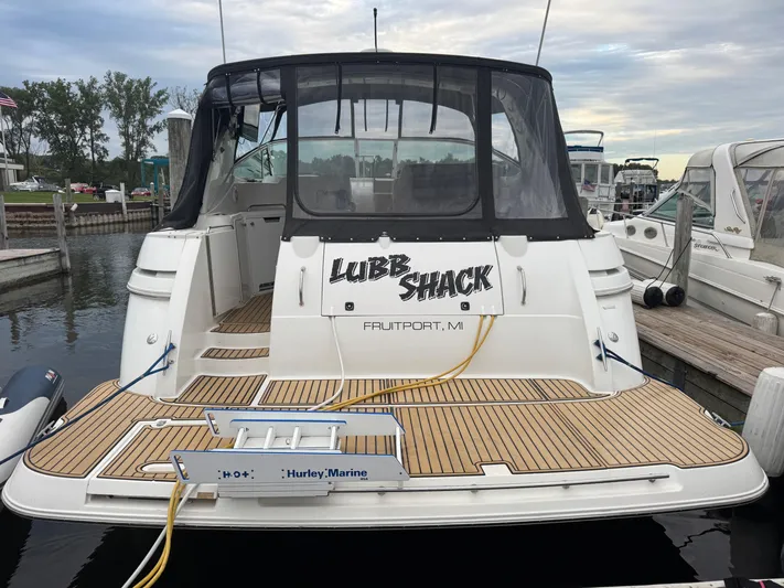  Yacht Photos Pics 2000 Cruisers Yachts 3870 Express docked, featuring a spacious deck and custom nameplate.