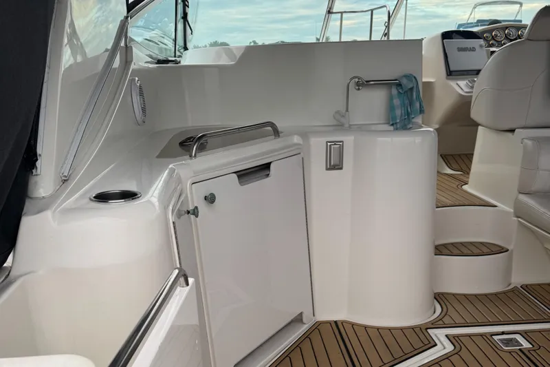  Yacht Photos Pics 2000 Cruisers Yachts 3870 Express interior with sink, seating, and wooden flooring.