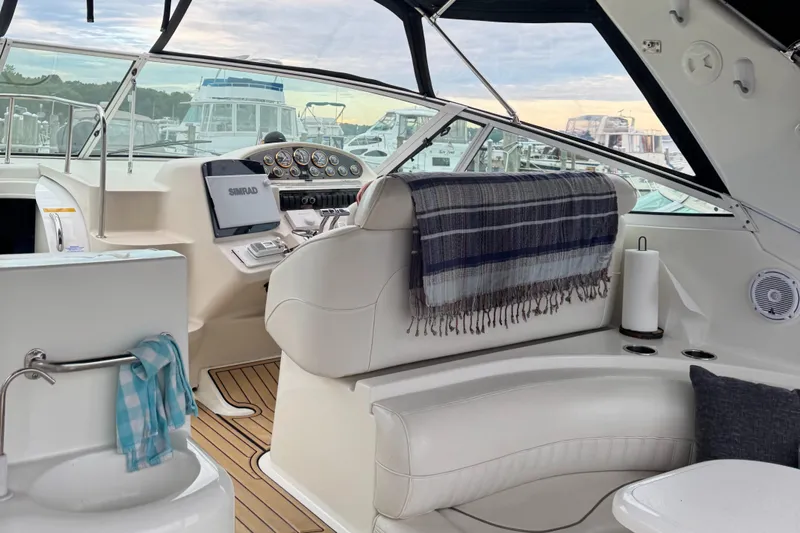  Yacht Photos Pics 2000 Cruisers Yachts 3870 Express cockpit with helm, seating, and nautical decor.