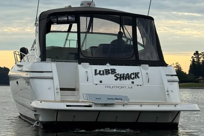  Yacht Photos Pics 2000 Cruisers Yachts 3870 Express boat named "Lubb Shack" on water at sunset.