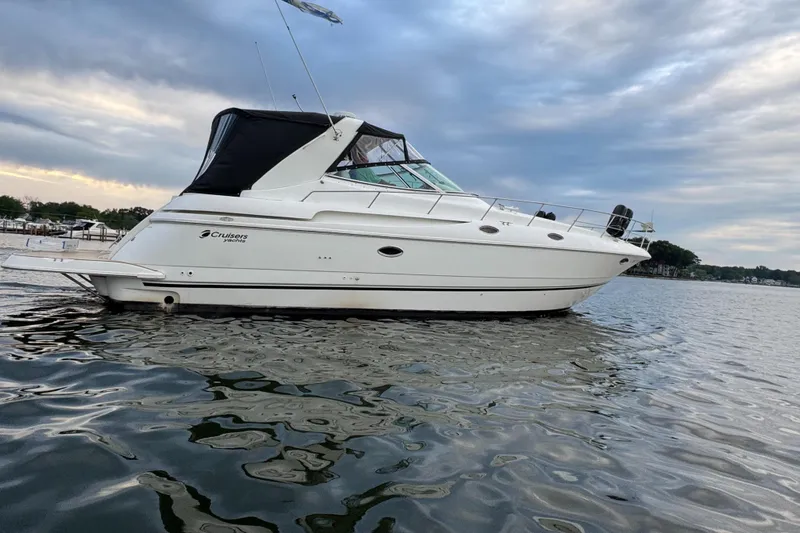  Yacht Photos Pics 2000 Cruisers Yachts 3870 Express on calm water under cloudy sky.