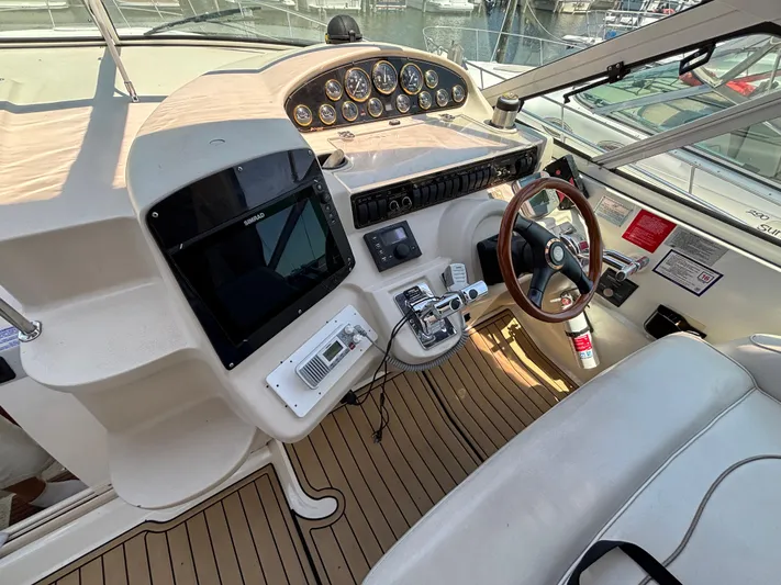  Yacht Photos Pics 2000 Cruisers Yachts 3870 Express helm with steering wheel, controls, and navigation equipment.